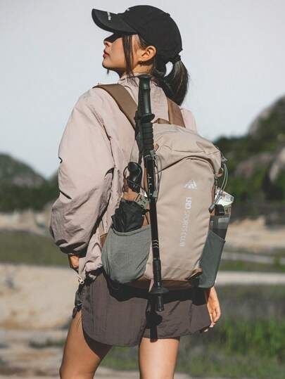 Traveller wearing a backpack at a mountain viewpoint