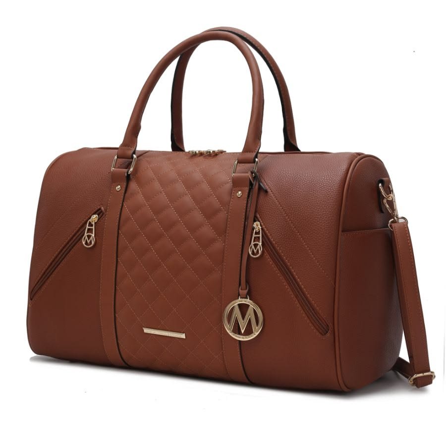 Leather weekender duffel bag on a wooden bench