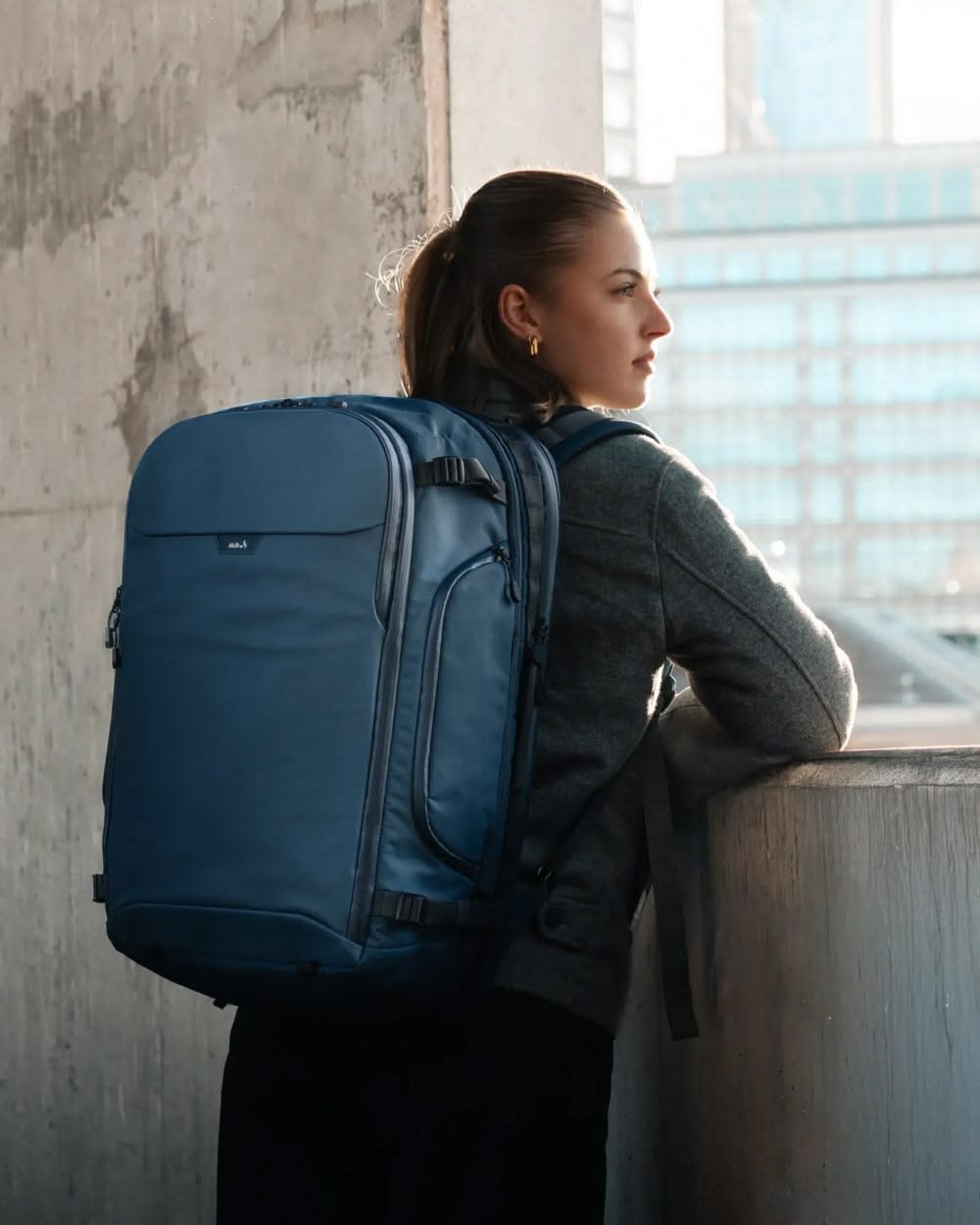 Traveller wearing a backpack at a mountain viewpoint