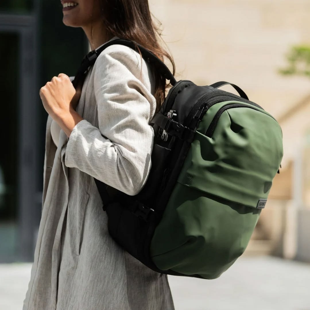 Traveller wearing a backpack at a mountain viewpoint